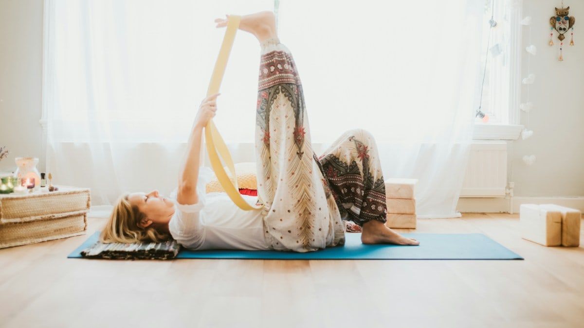 a woman doing a yoga pose on a yoga mat